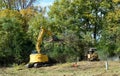 Excavator and Forestry Mulcher Clearing Land Royalty Free Stock Photo