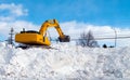 Excavator clearing snow