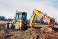 The excavator clears the ground to pave the road in private territory Royalty Free Stock Photo