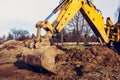 The excavator clears the ground to pave the road in private territory Royalty Free Stock Photo