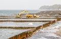 Excavator during the construction of a breakwater Royalty Free Stock Photo