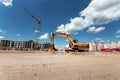 Excavator at a construction site against the background of a tower crane. Construction, technology Royalty Free Stock Photo