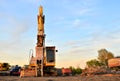 Excavator on a construction site cuts and crumbles old concrete and asphalt.