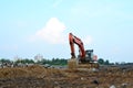 Excavator at a construction site during laying of underground pipes. Excavation contractor serving, trenching Royalty Free Stock Photo
