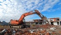 Excavator at a construction site during a sunny day demolishing old structures Royalty Free Stock Photo