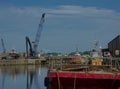 Excavator crane and vessels at Glasson Dock Marina. Variety of vessels.