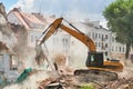Excavator crasher machine at demolition on construction site