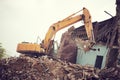 Excavator crasher machine at demolition on construction site