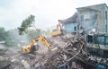 Excavator crasher machine at demolition on construction site