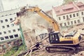 Excavator crasher machine at demolition on construction site