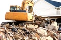 Excavator on damaged building