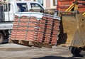 Excavator delivers paving stones