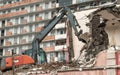 Excavator demolish or remove old ruined building in rainy day. Old house demolition on construct cite for renovation new