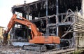 Excavator demolishes an abandoned industrial site for the urban redevelopment.