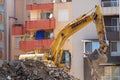 Excavator demolishes a house in a residential area of Varna