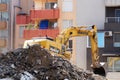 Excavator demolishes a house in a residential area