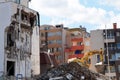 Excavator demolishes a house in a residential area