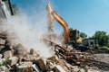 Excavator destroy old house. Demolition of building Royalty Free Stock Photo