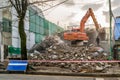 Excavator destroying old house, red line with words danger in english and korean on foreground, Daejeon, South Korea, 10 oktober