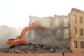 Excavator destroys old house.