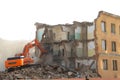 Excavator destroys old house.