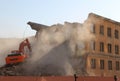 Excavator destroys old house.