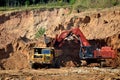 Excavator developing the sand in the opencast and loading it to the heavy dump truck. Royalty Free Stock Photo