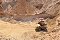 Excavator developing the sand on the opencast and loading it to the heavy dump truck.