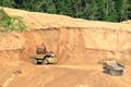 Excavator developing the sand on the opencast and loading it to the heavy dump truck.