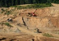 Excavator developing the sand on the opencast and loading it to the heavy dump truck. Processing of loose material in mining