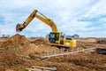 Excavator dig the trenches at a construction site. Trench for laying external sewer pipes. Sewage drainage system for a multi-