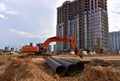 Excavator dig the trenches at a construction site. Trench for laying external sewer pipes. Sewage drainage system for a multi-