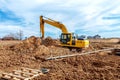 Excavator dig the trenches at a construction site. Trench for laying external sewer pipes. Sewage drainage system for a multi-