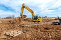 Excavator dig the trenches at a construction site. Trench for laying external sewer pipes. Sewage drainage system for a multi-