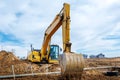 Excavator dig the trenches at a construction site. Trench for laying external sewer pipes. Sewage drainage system for a multi-