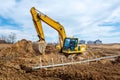 Excavator dig the trenches at a construction site. Trench for laying external sewer pipes. Sewage drainage system for a multi-