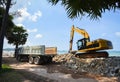 Excavator digger stone and Dump truck working on construction site / backhoe loader on the beach sea ocean Royalty Free Stock Photo