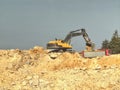 Excavator Digger Stone And Dump Truck Working On Hill