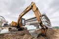 Excavator or digger working on office and warehouse building construction