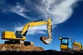 excavator digging against the blue sky hydraulic power large shovel Royalty Free Stock Photo