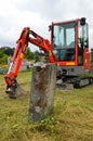 Excavator for digging a grave