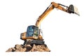 Excavator digging through isolated earth at a construction site during the golden hour of sunset Royalty Free Stock Photo