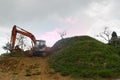 Excavator digging land. Construction site with heavy machinery equipment on the hill
