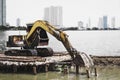 Excavator or digging machine working bucket digging ground in canal the process of construction site of the embankment for