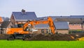 Excavator digging and moving sand, construction groundwork in Rucphen, The Netherlands, 31 January, 2020