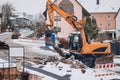 Excavator Digging Soil at Winter Construction Site Royalty Free Stock Photo