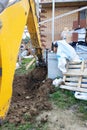 The excavator digging a trench near a cable house for a small bucket Royalty Free Stock Photo