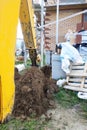 The excavator digging a trench near a cable house for a small bucket Royalty Free Stock Photo