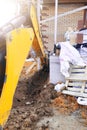 The excavator digging a trench near a cable house for a small bucket Royalty Free Stock Photo