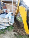 The excavator digging a trench near a cable house for a small bucket Royalty Free Stock Photo